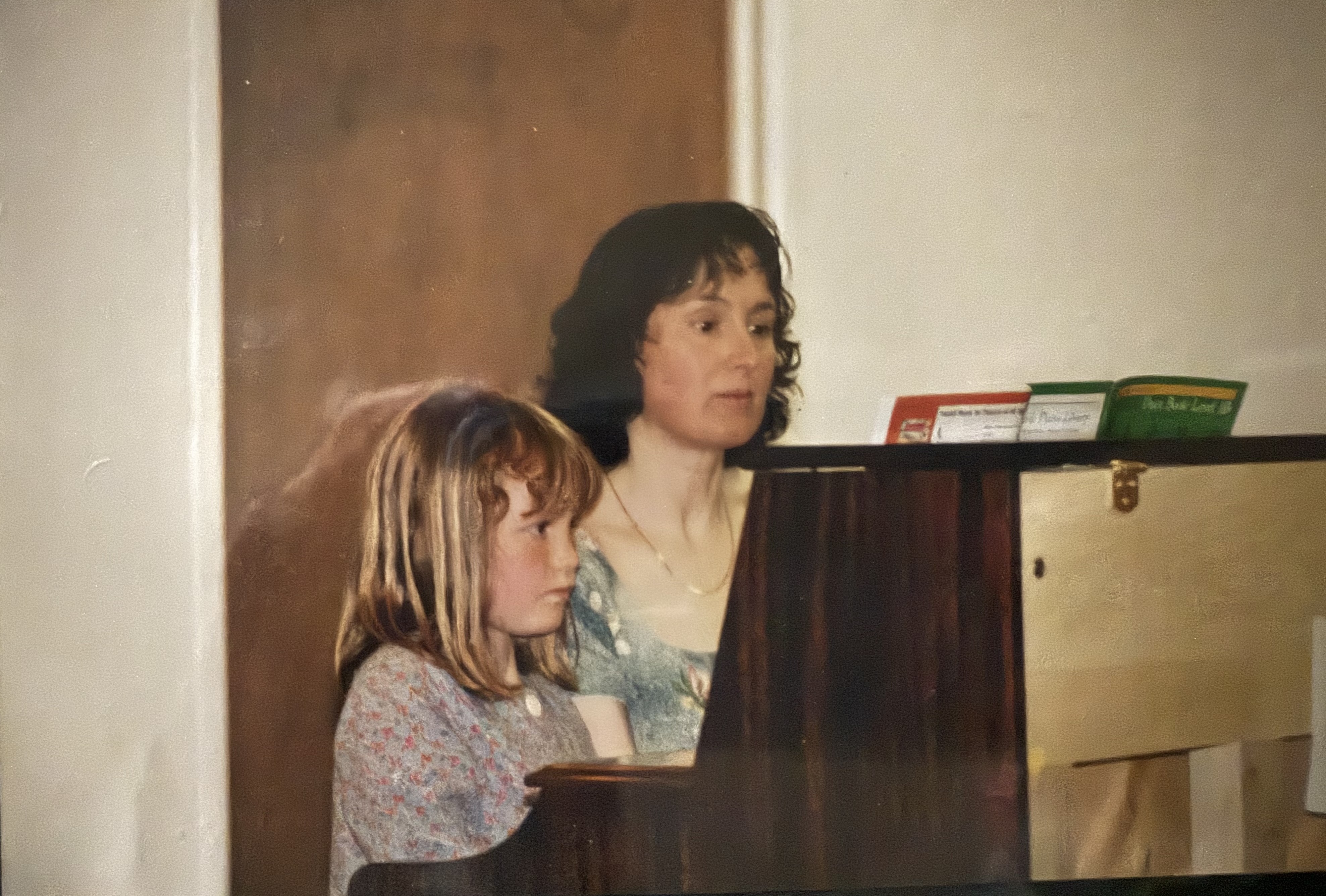 Una and Maree perform at a piano recital, 1998